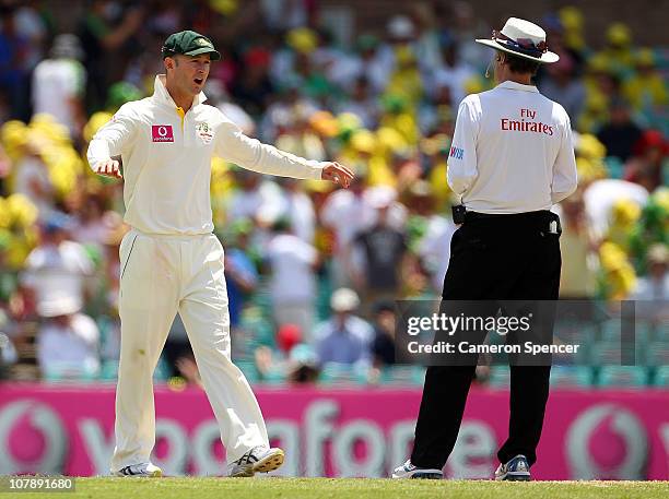 Captain Michael Clarke speaks with umpire Billy Bowden as a wicket was referred during day four of the Fifth Ashes Test match between Australia and...