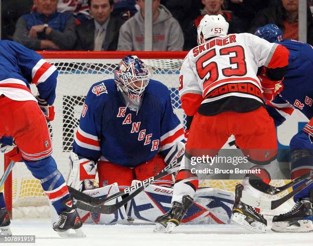 Henrik Lundqvist of the New York Rangers blocks the net as Jeff Skinner of the Carolina Hurricanes looks for a rebound at Madison Square Garden on...