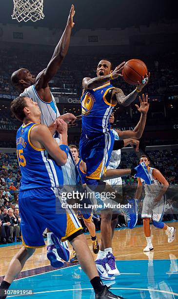 Monta Ellis of the Golden State Warriors attempts a layup while being guarded by Emeka Okafor of the New Orleans Hornets on January 5, 2011 at the...