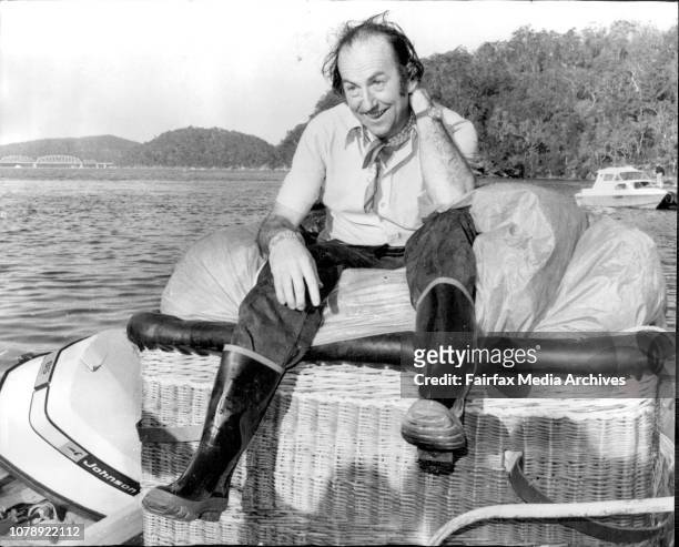Mr. Roger Meadmore after coming ashore near by boat at Kangaroo Point, with his balloon wrapped up in the basket. A hot air balloon broke loose from...