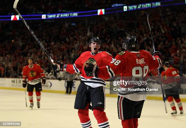 Tomas Kopecky of the Chicago Blackhawks celebrates his 2nd period goal with teammate Patrick Kane against the Dallas Stars at the United Center on...