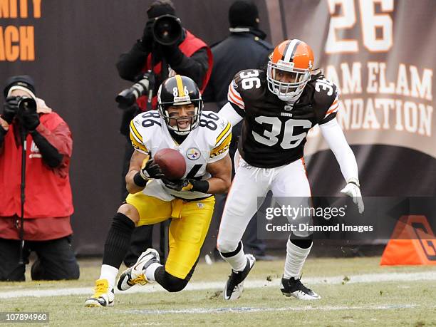 Wide receiver Hines Ward of the Pittsburgh Steelers catches a pass as defensive back Coye Francies of the Cleveland Browns looks on during a game on...