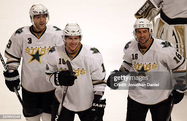 Stephane Robidas, James Neal and Adam Burish of the Dallas Stars smile as they leave the ice after a win over the Chicago Blackhawks at the United...