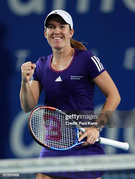 Justine Henin of Belgium celebrates winning her singles match against Ana Ivanovic of Serbia on day six of the Hopman Cup at The Burswood Dome on...