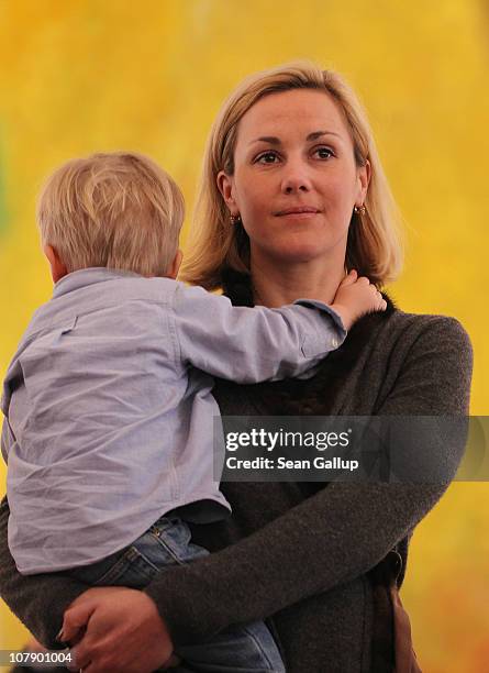 German First Lady Bettina Wulff carries her son Linus at a reception for child Epiphany carolers at Bellevue Presidential Palace on January 6, 2011...
