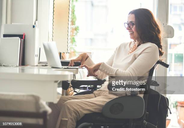 woman with disability working - wheelchair stock pictures, royalty-free photos & images