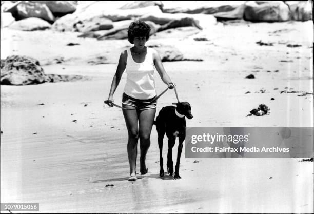 Jill Fletcher with her greyhound National Lee at Toowoon Bay, near the Entrance. November 18, 1982. .