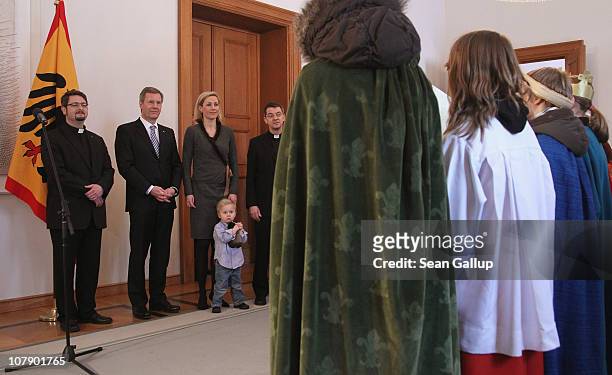 German President Christian Wulff and his wife Bettina, accompanied by their son Linus receive child Epiphany carolers at Bellevue Presidential Palace...