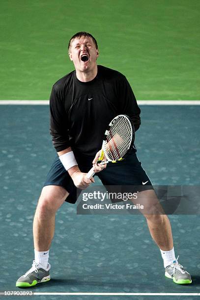 Yevgeny Kafelnikov of Russia reacts during his doubles match with Vera Zvonareva against Venus Williams and John McEnroe of the USA on day two of the...