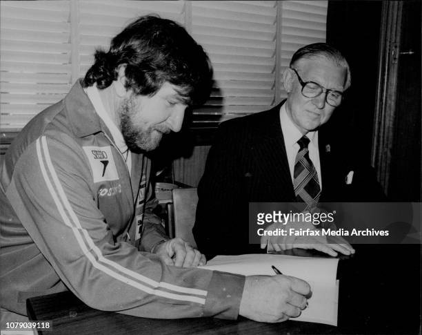 Mr Ken Warby signs an agreement with Speedo Managing Director Mr Bill MacRae at their Artarmon offices.World Water Speed Record holder Mr Ken Warby...