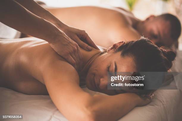 couple relaxing at the spa - massage couple stock pictures, royalty-free photos & images