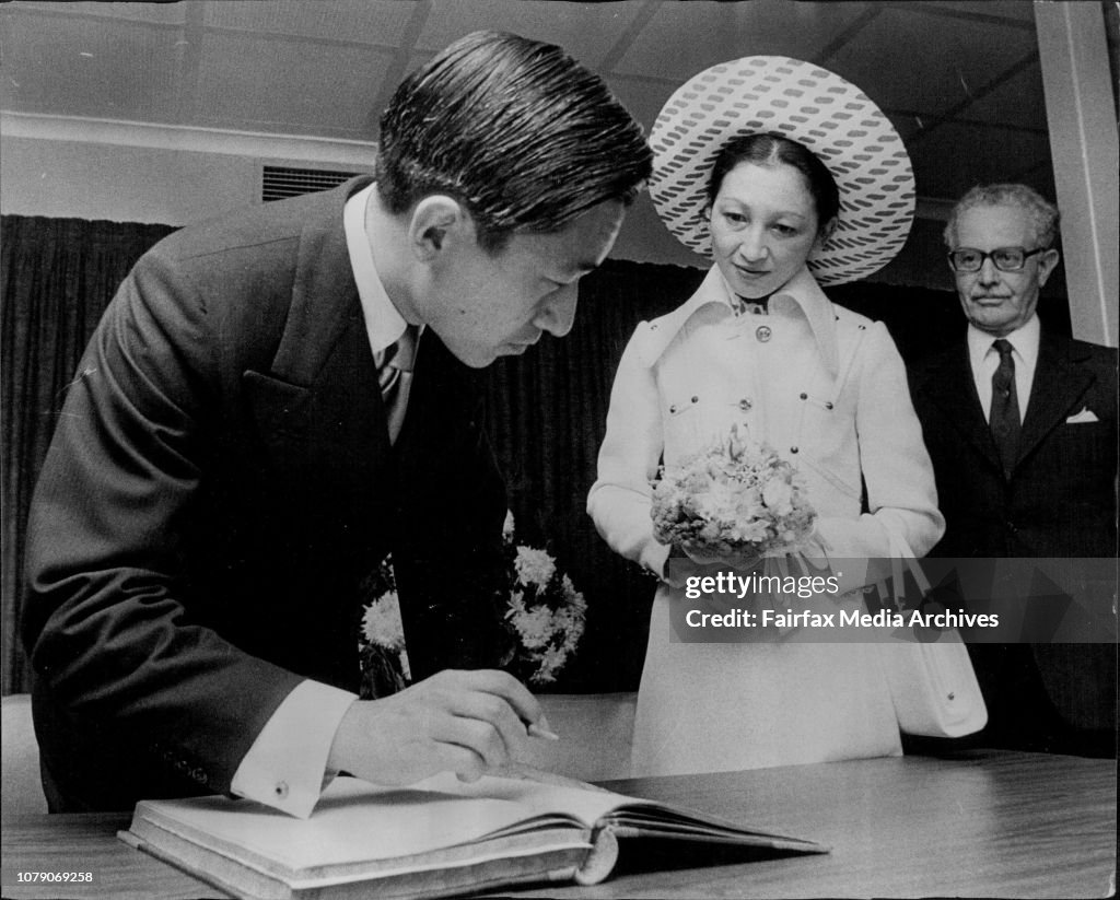 Visit of the Crown Prince of Japan to Sydney Hospital signs visitor book at the Kanematsu Memorial Institute watched by the Princess.