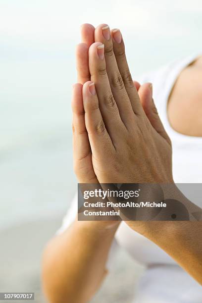 woman's clasped hands in prayer position - 祈る 手 ストックフォトと画像