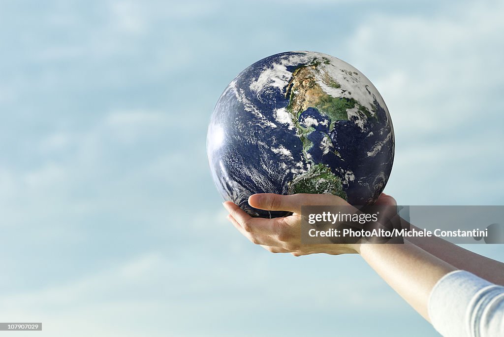 Holding fitness ball in cupped hands