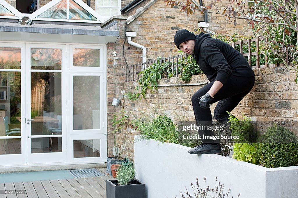 Burglar climbing on wall