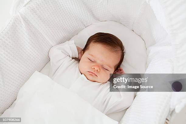 baby sleeping in a bassinet - cute baby sleeping stock pictures, royalty-free photos & images