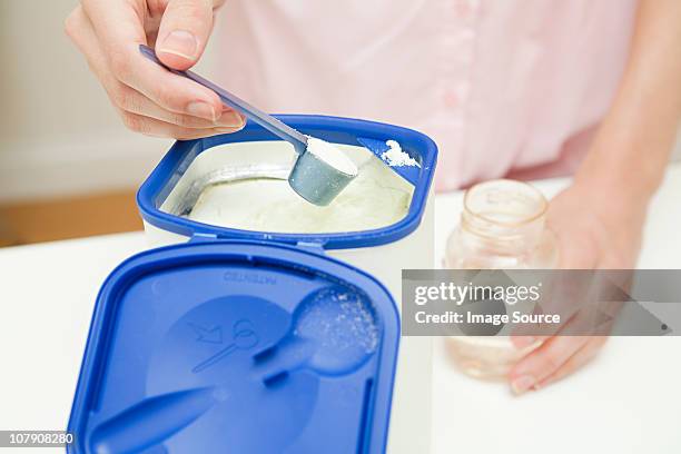 close up of mother preparing baby formula - milk powder stock pictures, royalty-free photos & images