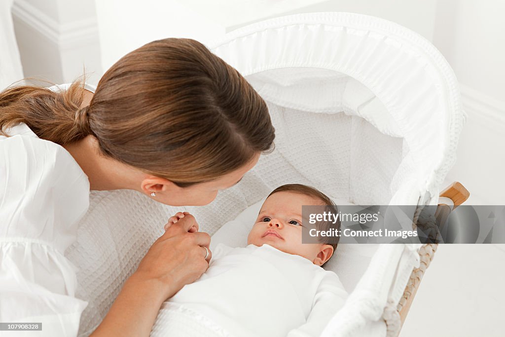 Mother with baby in bassinet