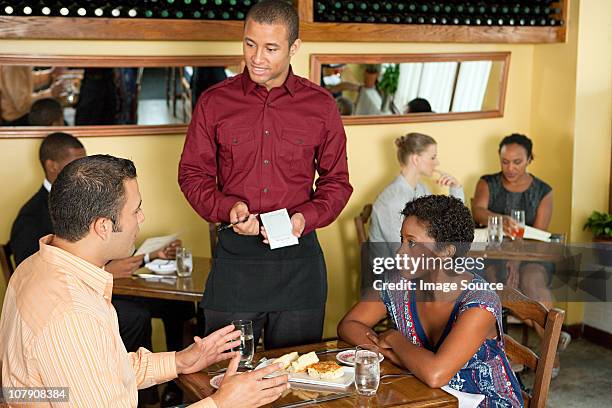 waiter taking customer orders in restaurant - waiter new york stock pictures, royalty-free photos & images