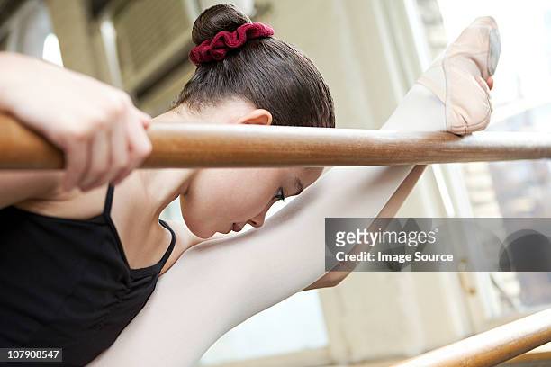 ballerina stretching at barre - leg stretch girl stock pictures, royalty-free photos & images