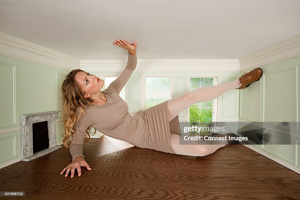 Giant young woman trapped in small room
