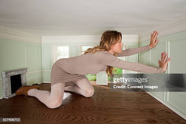 giant young woman trapped in small room - alice stock pictures, royalty-free photos & images