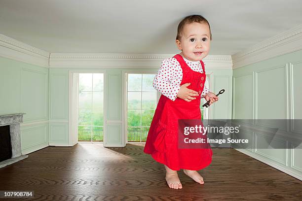 big toddler girl in a tiny room with a key - alice in wonderland stock-fotos und bilder