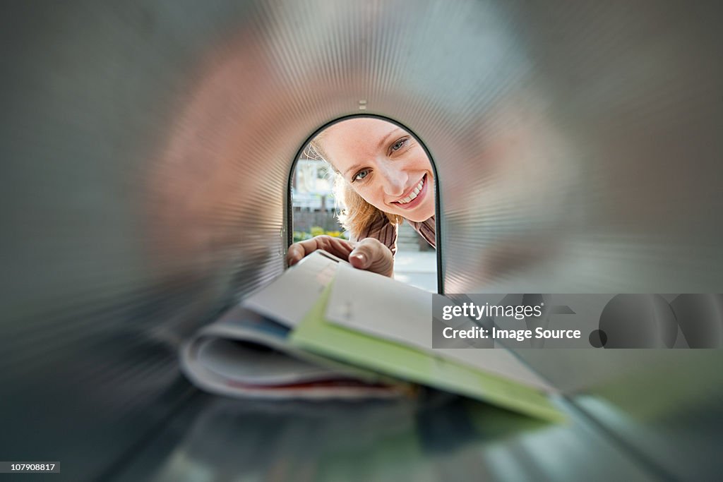 Woman collecting mail from mailbox