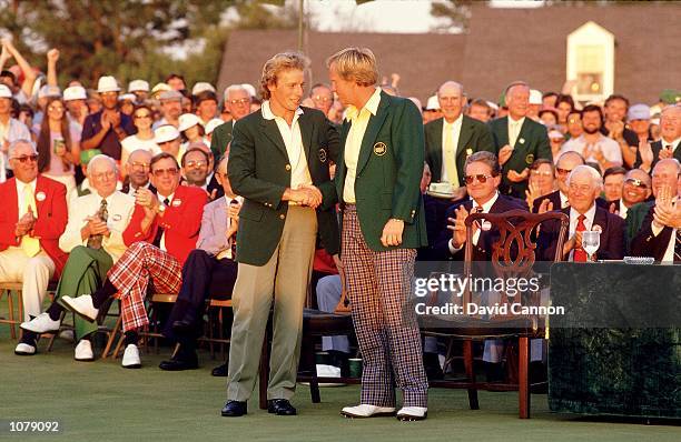 Jack Nicklaus of the USA receives the Green Jacket from previous winner Bernhard Langer of Germany after victory in the US Masters at Augusta...