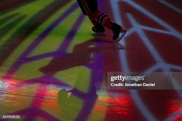 Member of the Chicago Blackhawks skates onto the ice during player introductions before a game against the Dallas Stars at the United Center on...