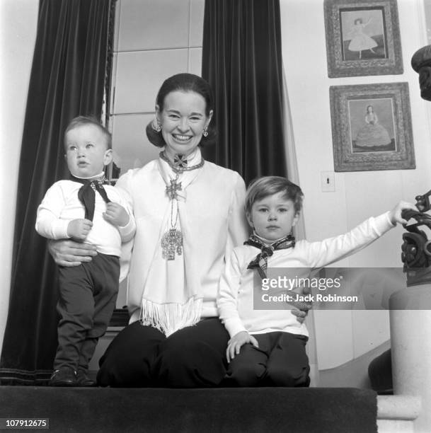 Socialite and heiress Gloria Vanderbilt poses for a portrait session with her sons Anderson Cooper and Carter Vanderbilt Cooper in their home in...