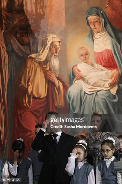 Russian President Dmitry Medvedev and his wife Svetlana Medvedeva attend an Orthodox Christmas service at Christ The Savior Cathedral in the early...