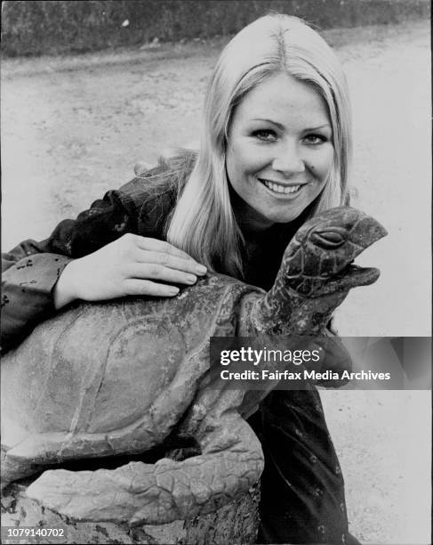 Kathy Troutt "inside" the Archibald fountain at Hyde Park admiring one of the turtles there. Kathy Troutt is a former deep sea diving champion and...