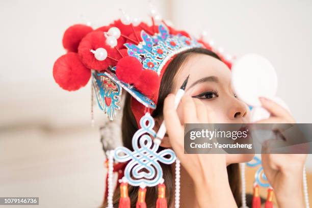 close-up of a chinese female opera actress is doing the make up - theatre costume stock pictures, royalty-free photos & images