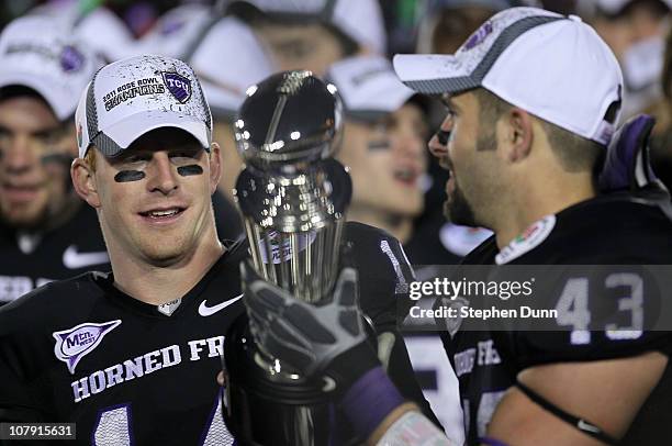 Quarterback Andy Dalton and linebacker Tank Carder of the TCU Horned Frogs celebrate with the Rose Bowl Championship Trophy after defeating the...