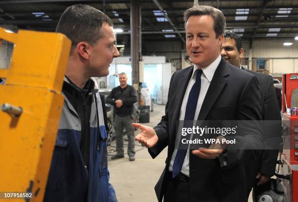 Prime Minister David Cameron visits the Adamsons Vehicle Care Centre as he campaigns with local Conservative candidate Kashif Ali on January 6, 2011...