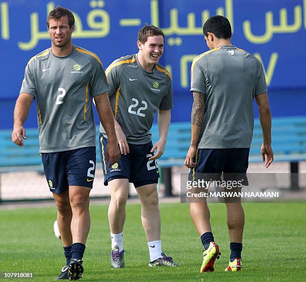 CAPTIONAustralian national football team captain Lucas Neill trains with teammates Neil Kilkenny and Tim Cahill at at Al-Wakra stadium in Doha on...