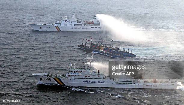 Picture taken on December 22 from a South Korean helicopter shows 12 Chinese fishing boats banded together with ropes to thwart an attempt by a South...