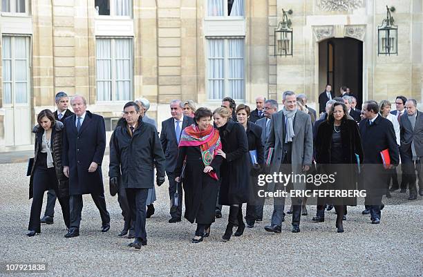 Members of the French government led by Prime Minister Francois Fillon arrive by foot at the Elysee Palace to give their New Year wishes to President...