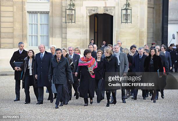 Members of the French government led by Prime Minister Francois Fillon arrive by foot at the Elysee Palace to give their New Year wishes to President...