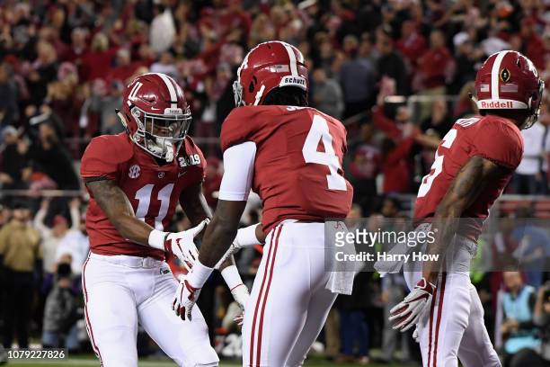 Jerry Jeudy of the Alabama Crimson Tide is congratulated by his teammate Henry Ruggs III after scoring a first quarter touchdown reception against...