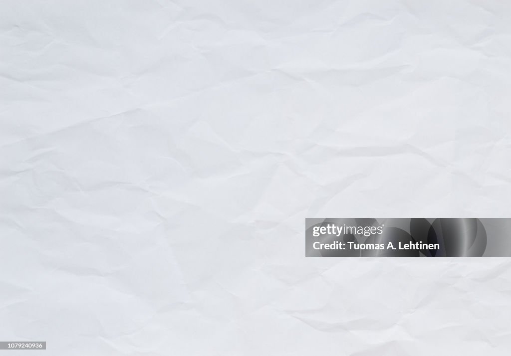High quality crumpled white and blank paper sheet texture background.