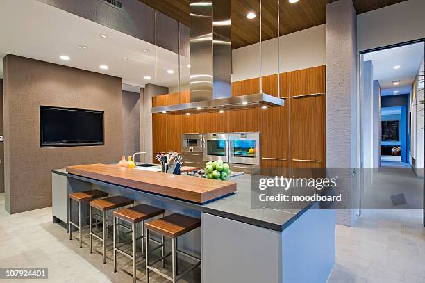 wood panelled spotlit kitchen in california home - kitchen island stock pictures, royalty-free photos & images