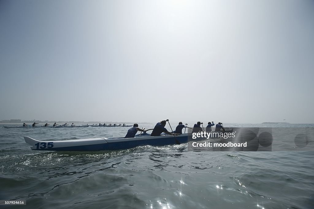 Outrigger canoeing team on water