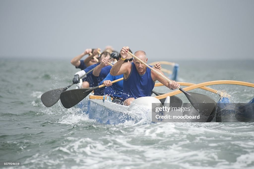 Outrigger canoeing team on water