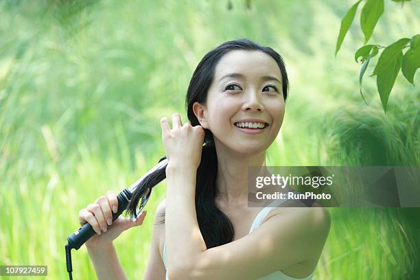 young korean woman - lockenstab stock-fotos und bilder