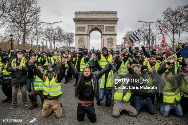 Protesters chant slogans during the 'yellow vests' demonstration on the Champs-Elysées near the Arc de Triomphe on December 8, 2018 in Paris France....