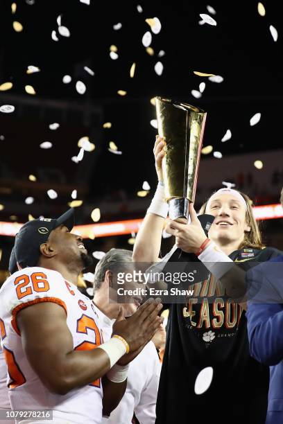 Adam Choice and Trevor Lawrence of the Clemson Tigers celebrate with the trophy after their teams 44-16 win over the Alabama Crimson Tide in the CFP...