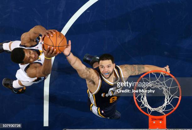 Rudy Gay of the Memphis Grizzlies rebounds against Deron Williams the Utah Jazz on January 7, 2011 at FedExForum in Memphis, Tennessee. NOTE TO USER:...