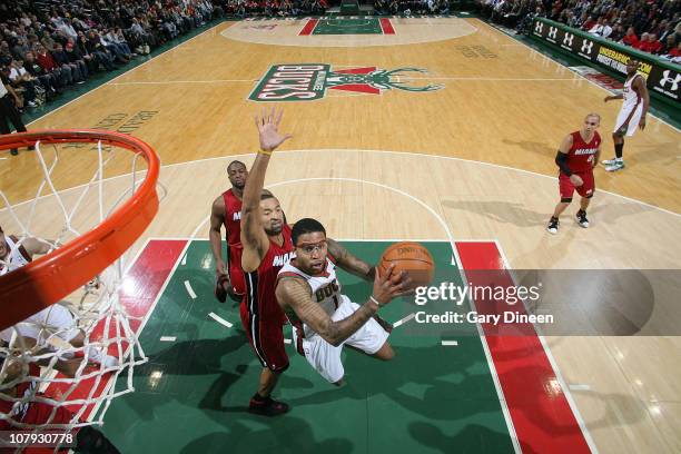 Chris Douglas-Roberts of the Milwaukee Bucks shoots a layup against Juwan Howard of the Miami Heat during the NBA game on January 7, 2011 at the...